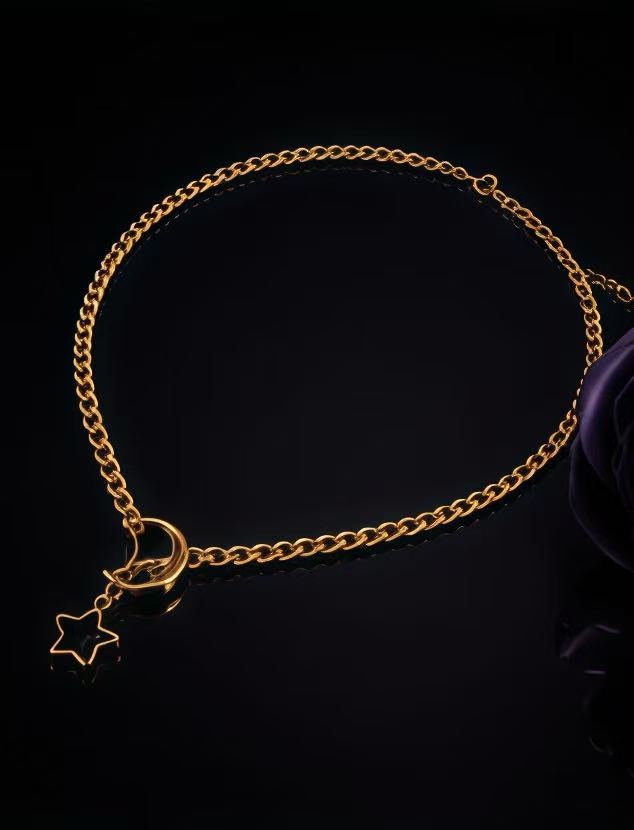 Gold celestial chain necklace with moon star pendant detail