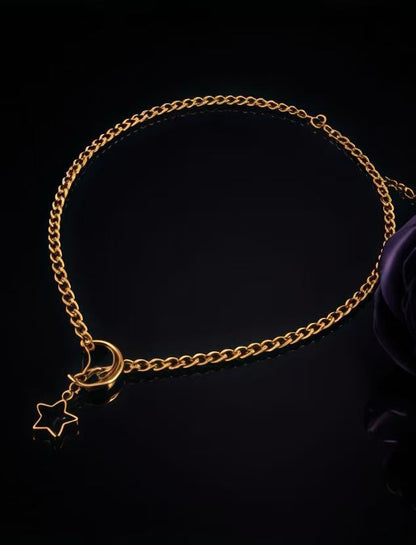 Gold celestial chain necklace with moon star pendant detail